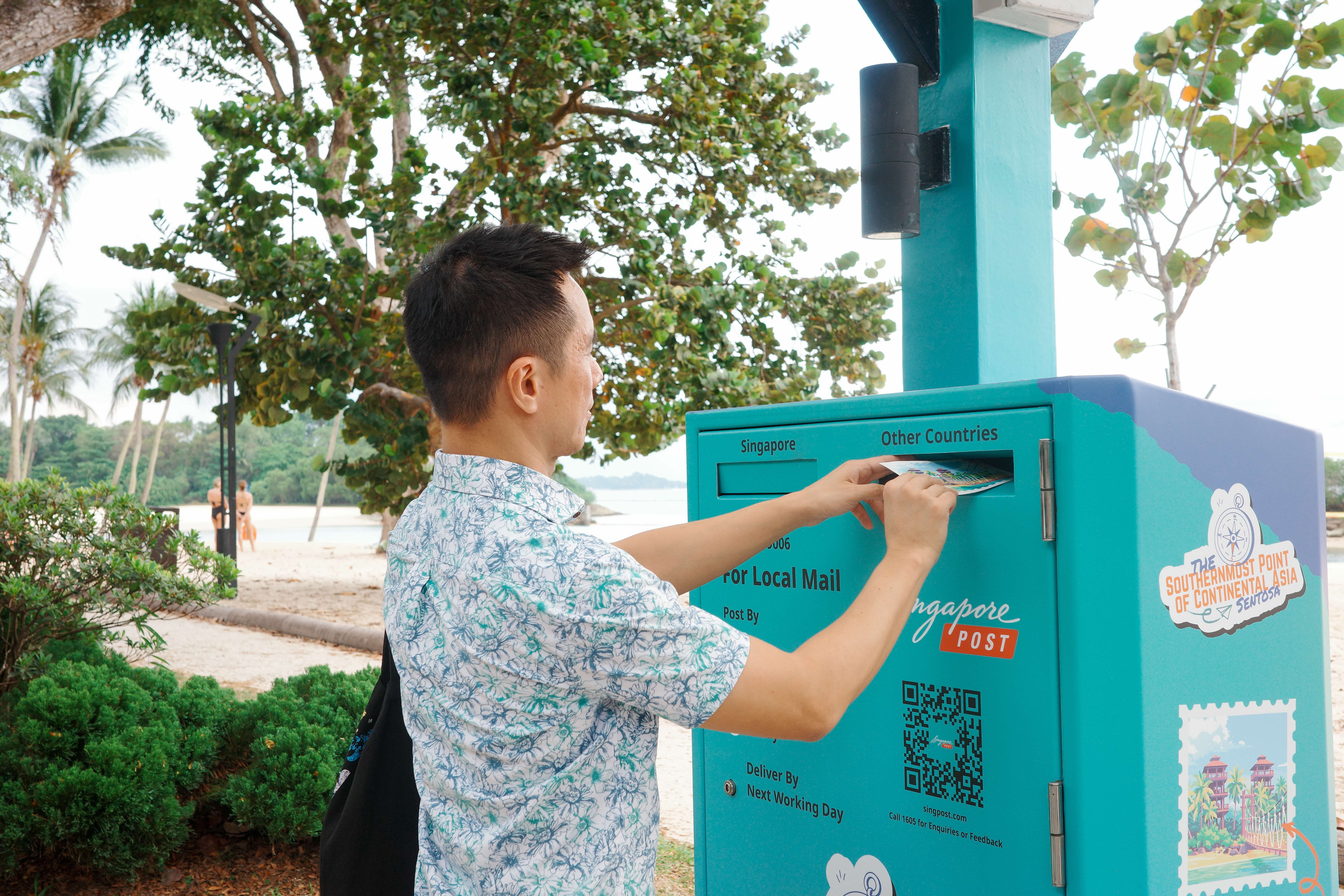 Man posting a postcard